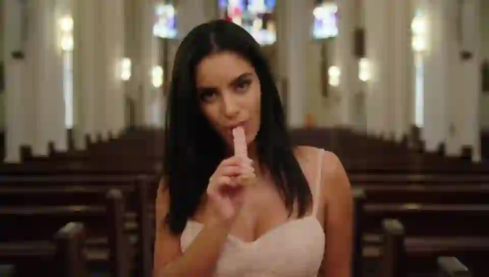 A beautiful woman in chirch, start stripping and suck a on HunyuanVideo