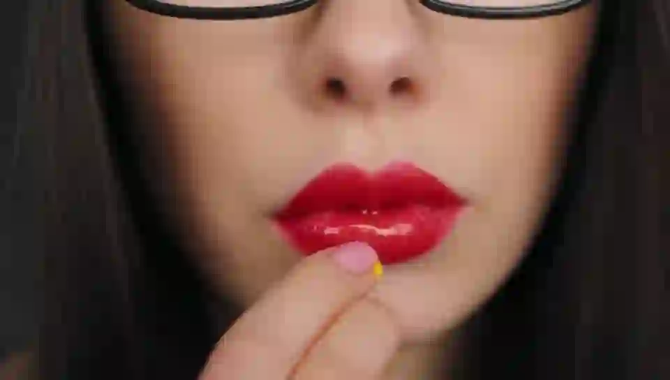 A beautiful woman with glaases and glowing yellow eyes and on HunyuanVideo